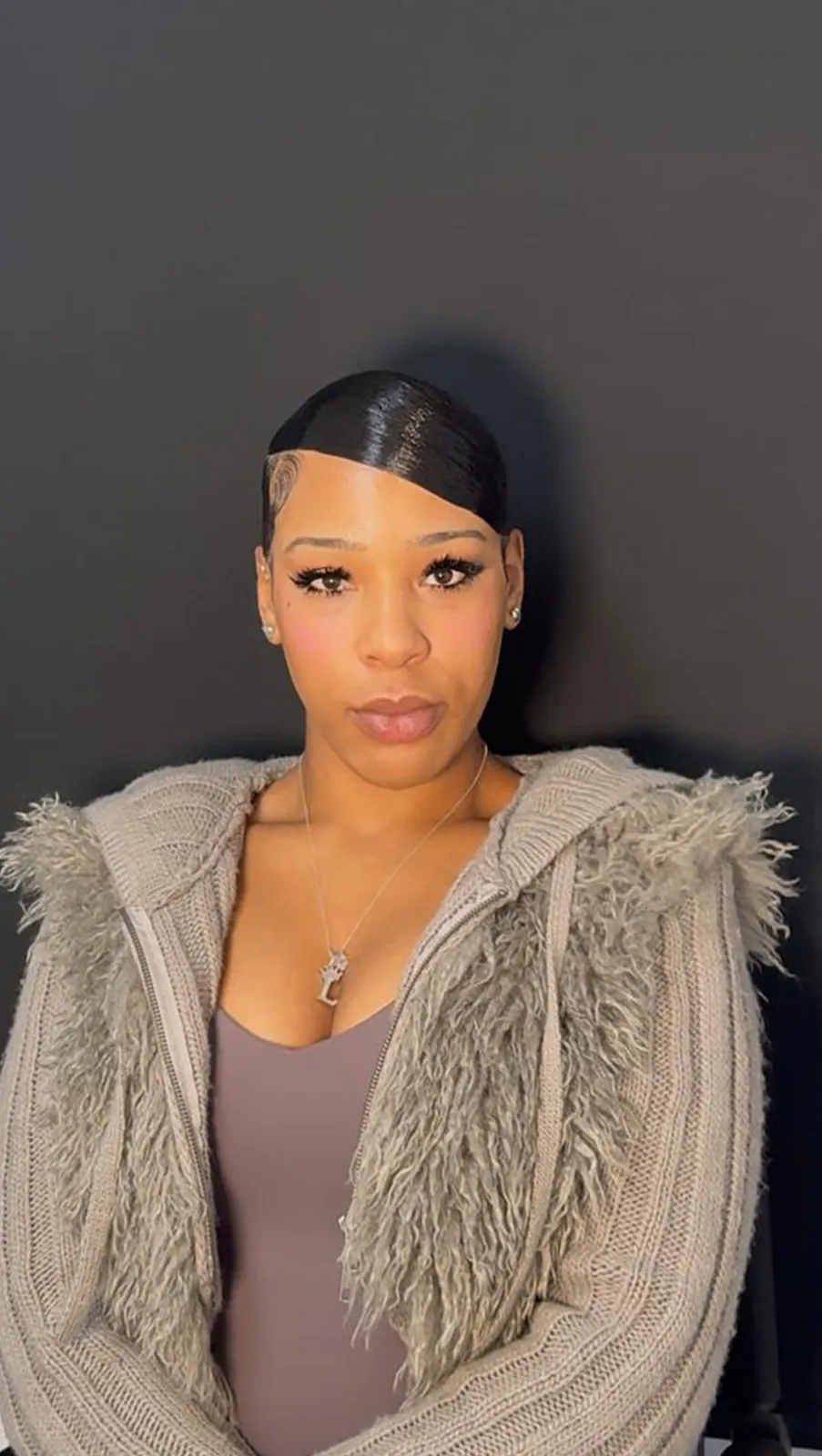Sharp side part slicked back, front view